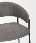 Gray upholstered chair with black metal legs on a light gray background