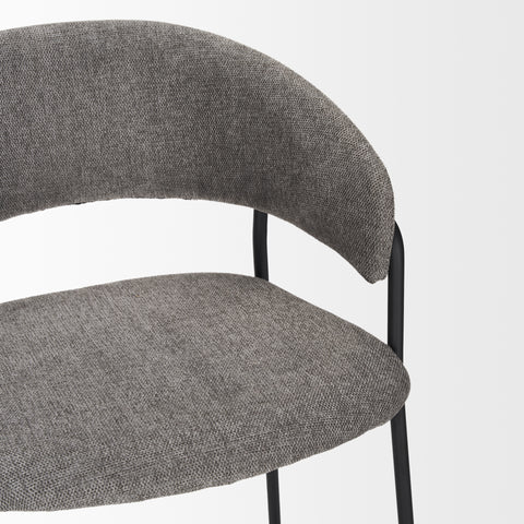Gray upholstered chair with black metal legs on a light gray background