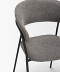 Gray upholstered chair with black metal legs on a white background