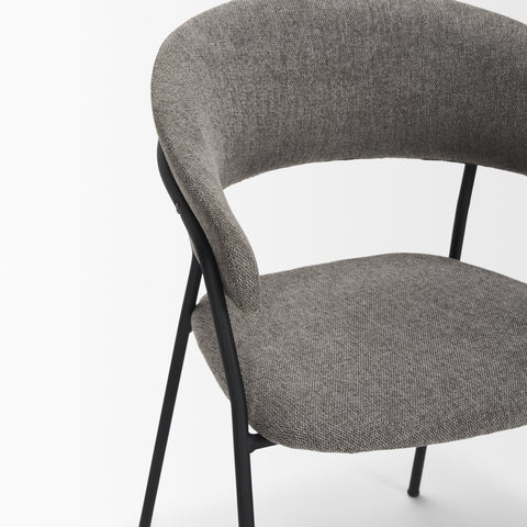 Gray upholstered chair with black metal legs on a white background
