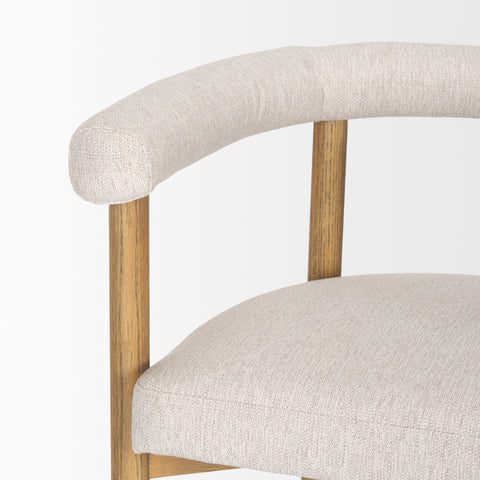 Close-up of a chair with beige fabric seat and backrest on a white background
