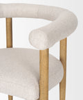 Chair with beige cushioned seat and backrest on a white background