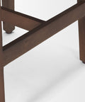 Close-up of a wooden chair leg on a white background