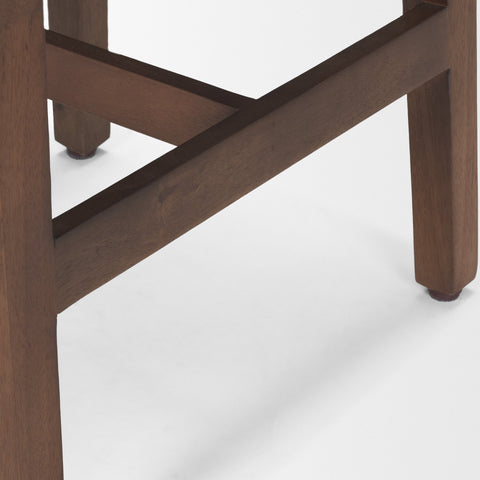 Close-up of a wooden chair leg on a white background