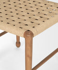 Woven stool with wooden legs on a white background