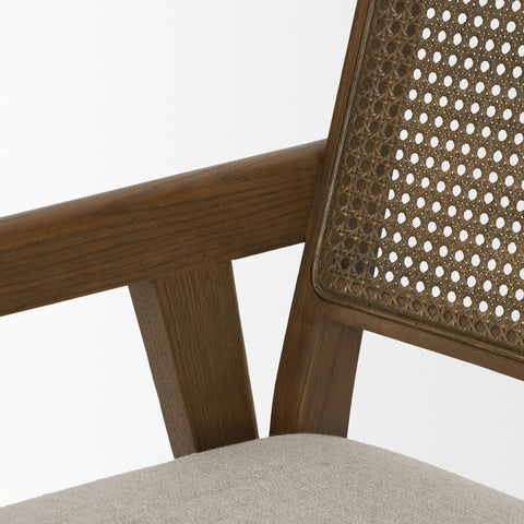 Close-up of a wooden chair with a woven backrest on a white background