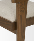 Close-up of a wooden chair with a beige cushion on a white background