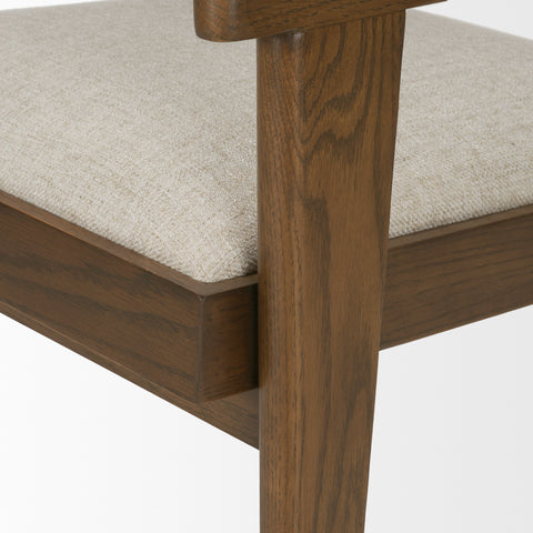Close-up of a wooden chair with a beige cushion on a white background