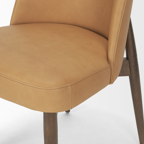 Close-up of a brown leather chair with wooden legs on a white background