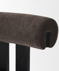 Brown upholstered bar stool with a black metal frame on a white background