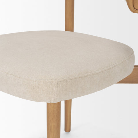 Close-up of a beige upholstered chair seat with wooden legs on a white background