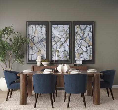 Dining room with a wooden table and blue chairs, featuring abstract wall art.