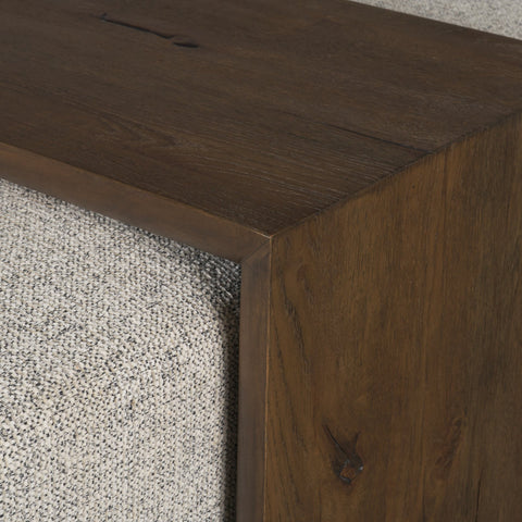 Close-up of a wooden surface with a textured gray carpet corner.