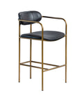 Bar stool with black leather seat and gold metal frame on a white background