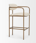 Bar stool with white cushioned seat and backrest on a gold metal frame against a white background