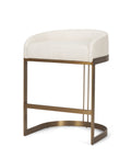 Bar stool with white cushioned seat and brass frame on a white background