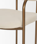 Chair with beige cushioned seat and gold metal frame on a white background