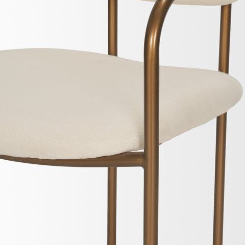 Chair with beige cushioned seat and gold metal frame on a white background