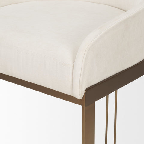 Close-up of a chair with a white cushioned seat and bronze frame on a light background