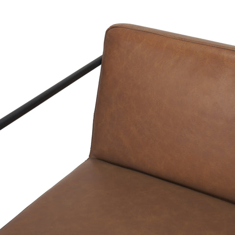 Brown leather chair with black metal frame on a white background