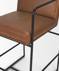 Brown leather chair with black metal frame on a white background