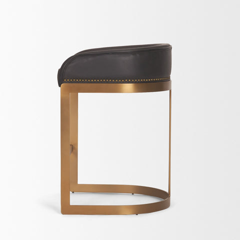 Bar stool with black leather seat and brass frame on a white background
