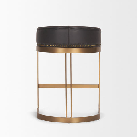 Decorative stool with black top and gold metal frame on a white background