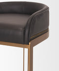 Close-up of a black leather chair with gold legs on a white background