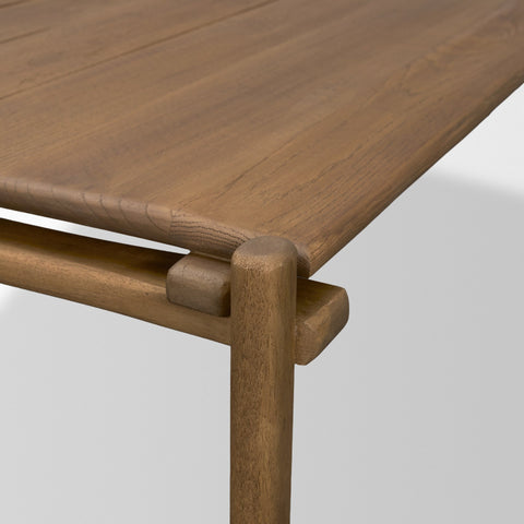 Close-up of a wooden table with a light brown finish on a white background