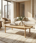Modern living room with a white sofa, wooden coffee table, and armchairs.