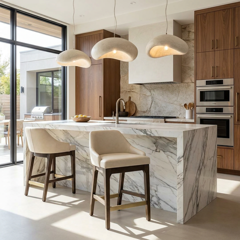 Modern kitchen with marble island, wooden cabinets, and pendant lights.
