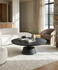 Modern living room with white sofa, black coffee table, and beige armchairs.