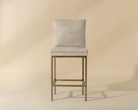 Beige bar stool with cushioned seat and backrest on a beige background