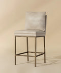 Beige bar stool with a metallic frame on a beige background