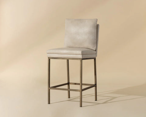 Beige bar stool with a metallic frame on a beige background