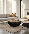 Modern living room with a gray sofa, coffee table, and armchair.