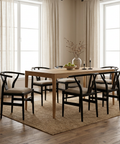 Dining room with wooden table and chairs in a well-lit room.