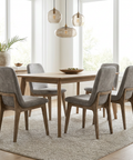 Dining room with wooden table and gray chairs in a bright room.