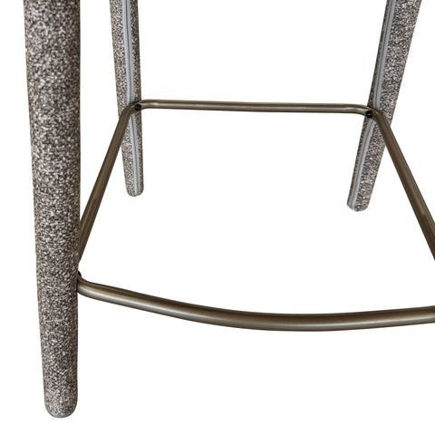 Close-up of a bar stool with textured legs on a white background