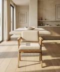 Modern dining room with wooden chairs and a neutral color palette.