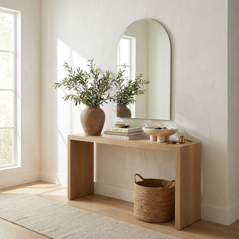 Wooden console table with decorative items against a white wall