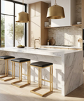 Modern kitchen with marble island, stools, and pendant lights.