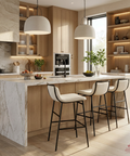 Modern kitchen with marble island, wooden cabinets, and white bar stools.