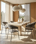 Modern dining room with a wooden table and gray chairs, large windows, and decorative elements.