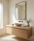 Bathroom vanity with wooden cabinet, sink, and mirror in a bright room.