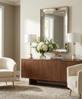 Living room with a wooden console table, mirror, and decorative items.