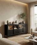 Modern living room with a black sideboard, beige sofa, and decorative items.