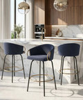 Modern kitchen with marble island and blue bar stools