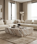 Modern living room with beige sofa, marble coffee table, and large windows.
