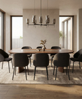 Dining room with a wooden table and gray chairs, featuring a modern chandelier.